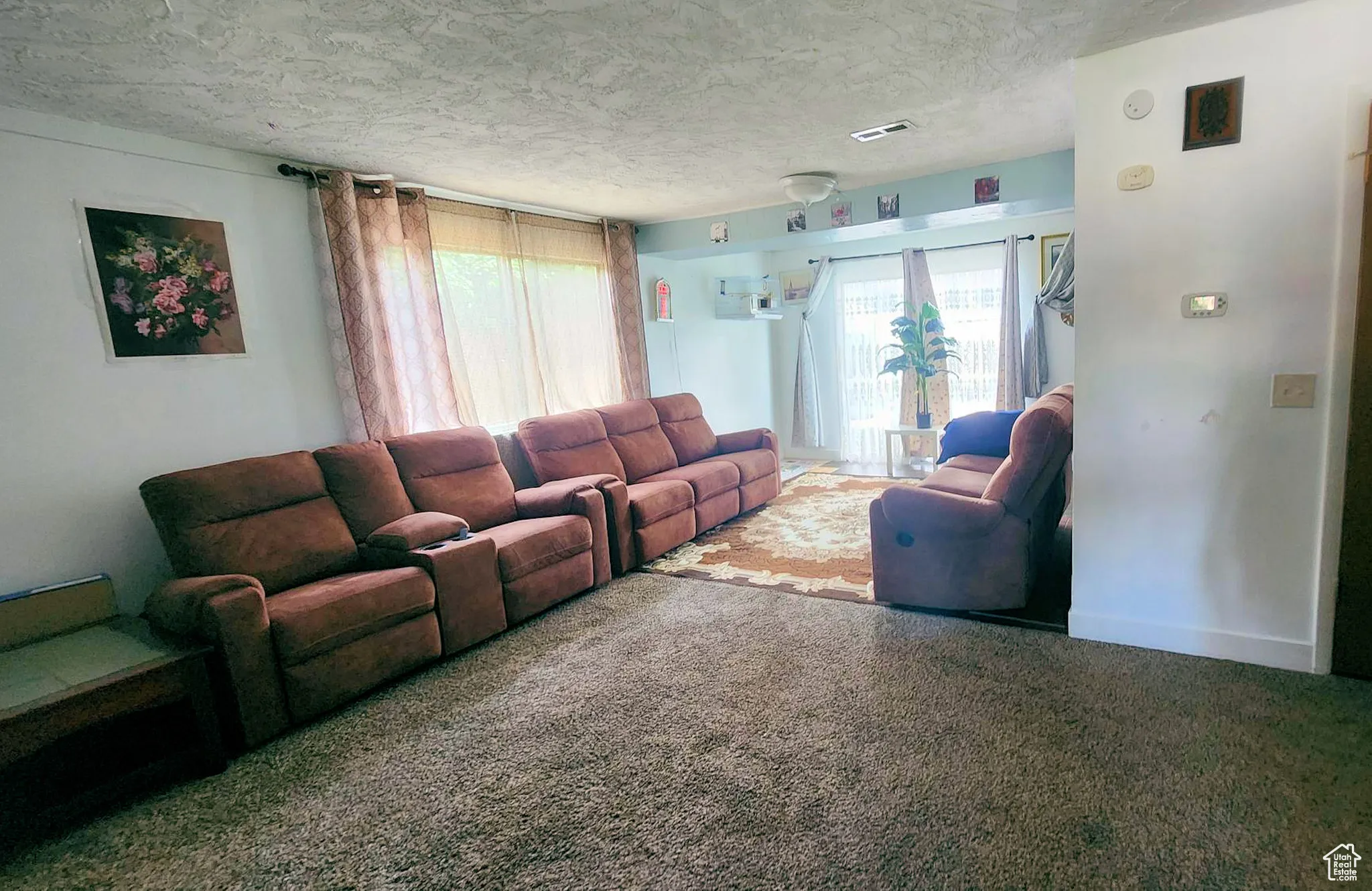 Carpeted living area with a textured ceiling