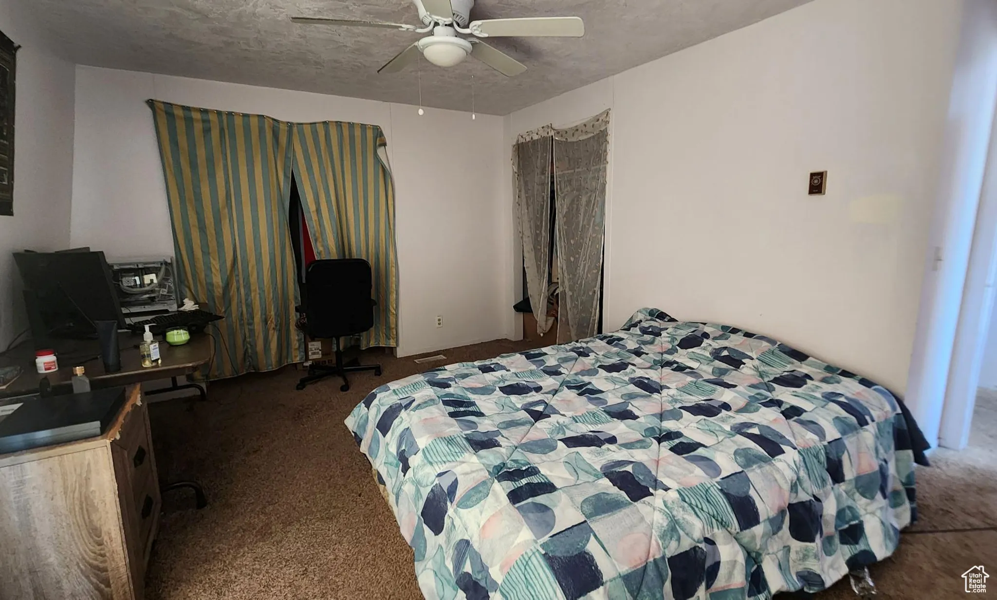 Carpeted bedroom with ceiling fan