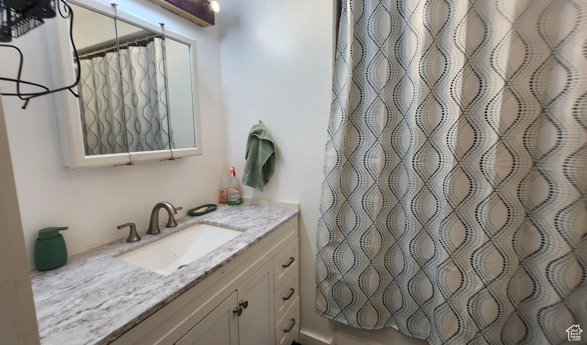 Full bath featuring vanity and a shower with curtain