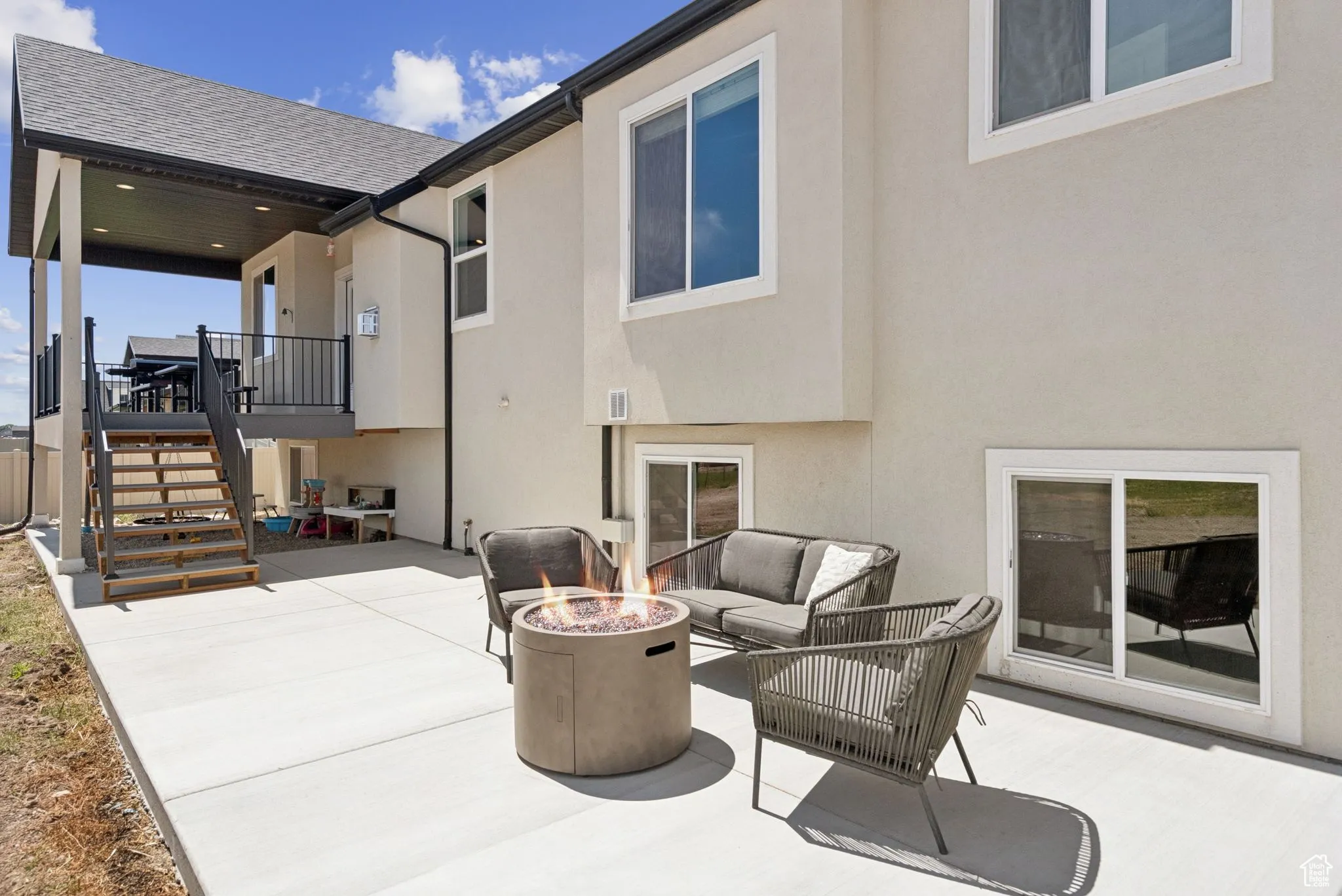View of patio featuring an outdoor living space with a fire pit and stairway