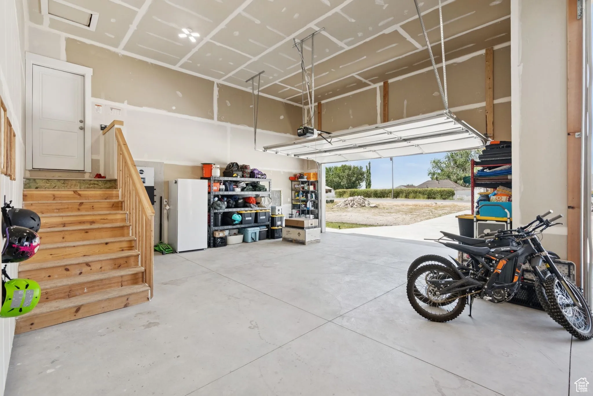 Garage featuring freestanding refrigerator