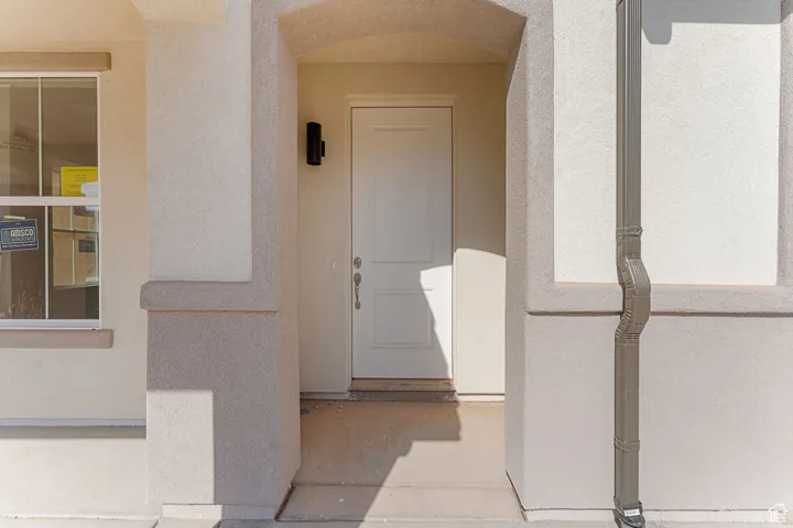 Entrance to property with stucco siding