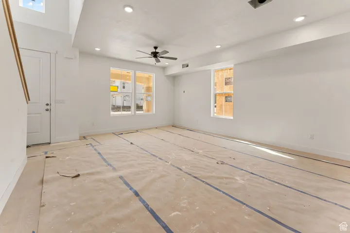 Unfurnished living room featuring recessed lighting and ceiling fan