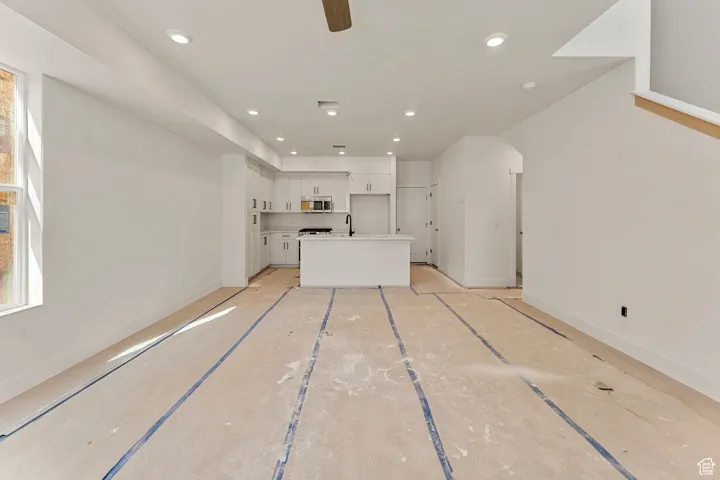 Unfurnished living room with recessed lighting and ceiling fan
