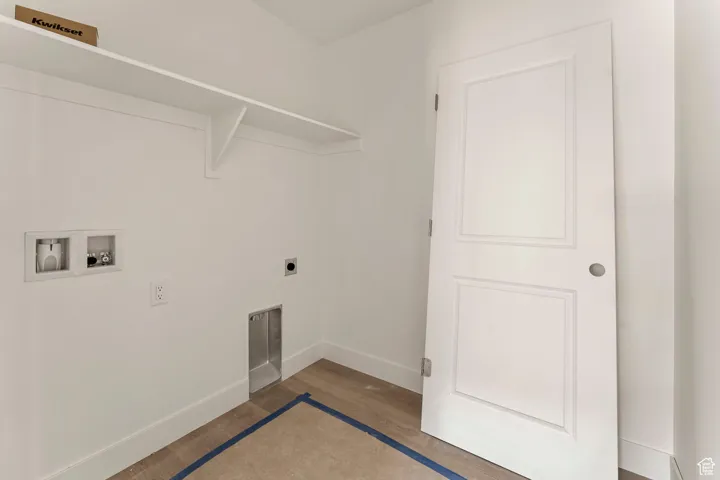 Laundry area featuring washer hookup, electric dryer hookup, and wood finished floors