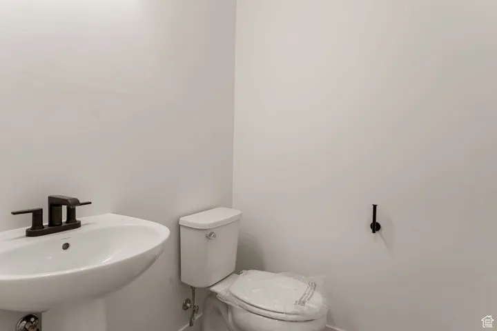 Bathroom featuring toilet and baseboards