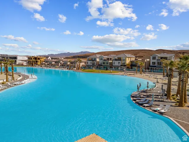 Community pool featuring a residential view, a mountain view, and a patio