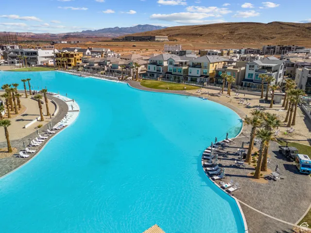 Aerial view of residential area with a mountain backdrop and a pool