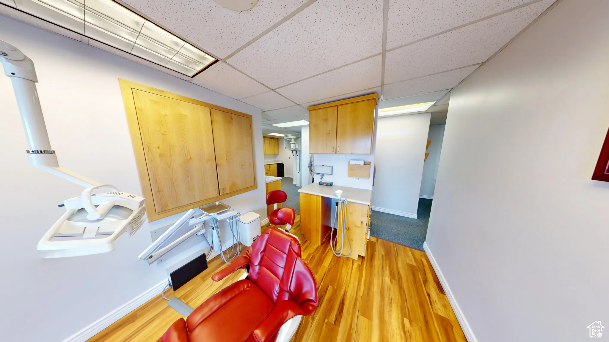 Kitchen featuring a paneled ceiling, light wood-style floors, and light countertops