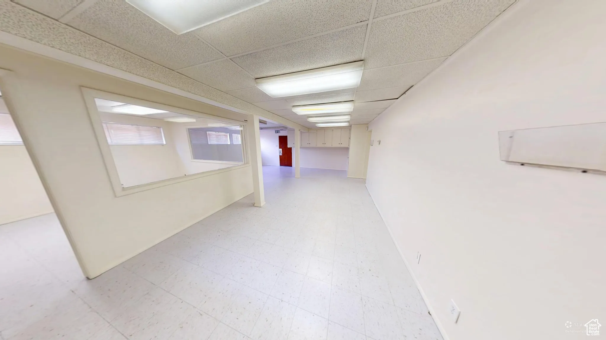 Below grade area featuring light floors and a drop ceiling