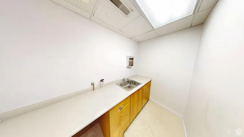 Laundry area featuring a sink and baseboards