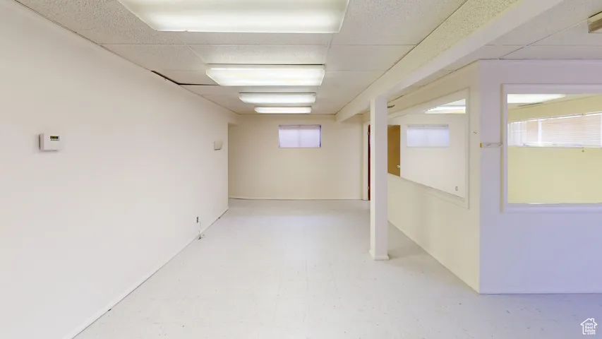 Below grade area featuring light floors and a drop ceiling