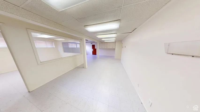 Below grade area featuring light floors and a drop ceiling