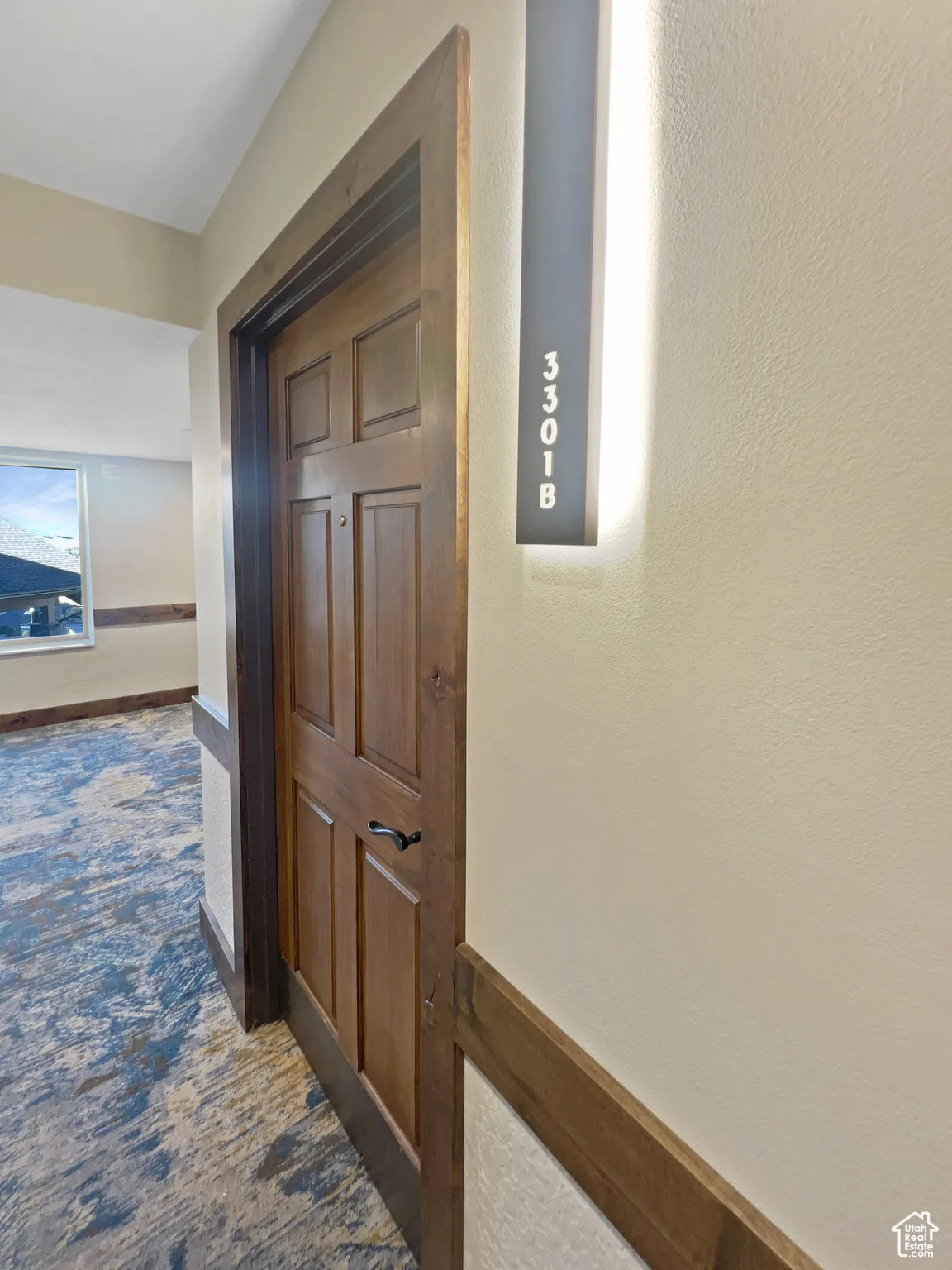 Hall featuring dark carpet