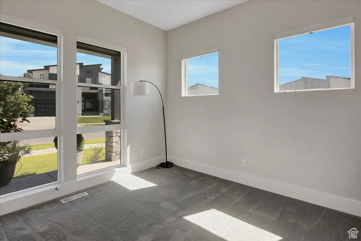 Unfurnished room with carpet floors and baseboards