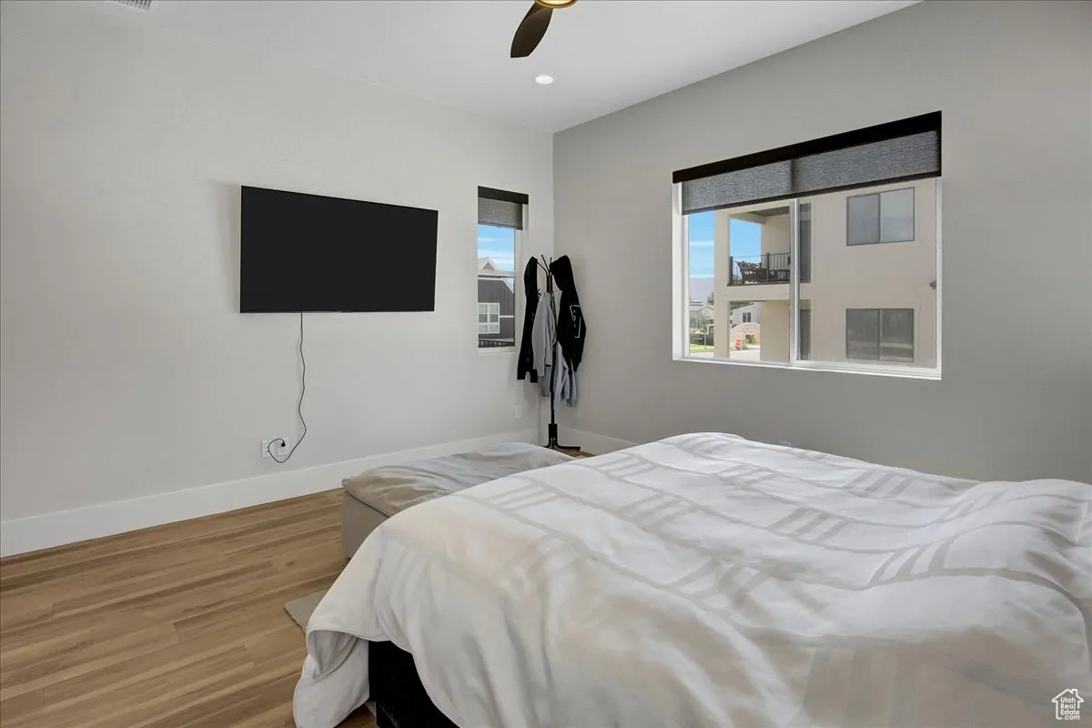 Bedroom featuring wood finished floors, a ceiling fan, and recessed lighting