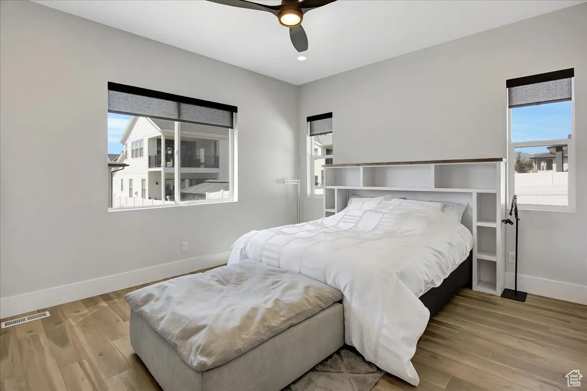 Bedroom with wood finished floors and ceiling fan