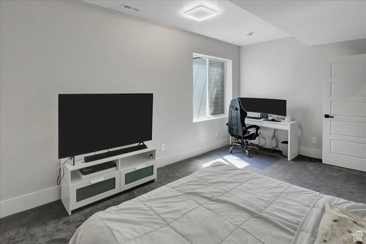 Bedroom featuring carpet flooring and an office area