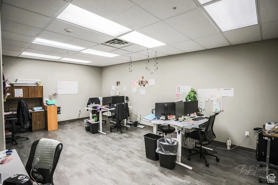 Office area featuring a paneled ceiling and baseboards