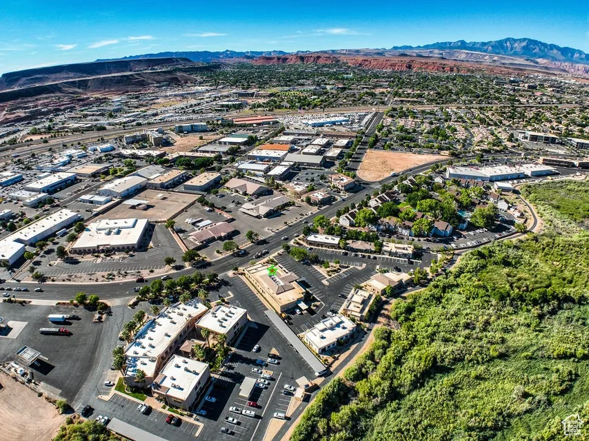 Aerial view of property's location featuring a mountainous background