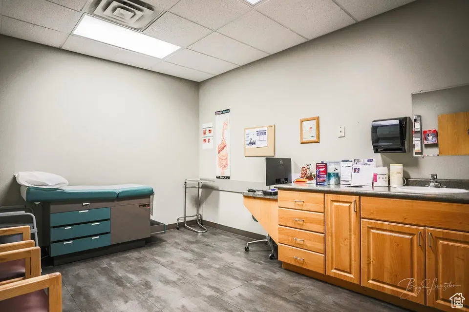 Office area with a drop ceiling and a sink