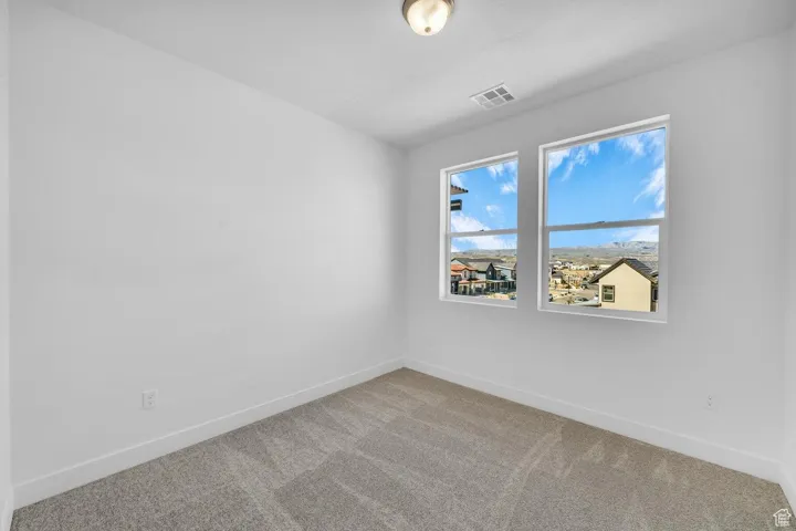 Unfurnished room featuring carpet flooring