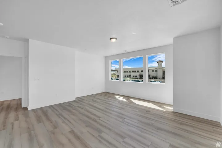 Spare room with wood finished floors and baseboards
