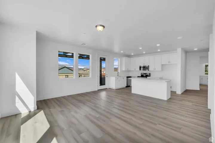 Unfurnished living room with light wood-type flooring and recessed lighting