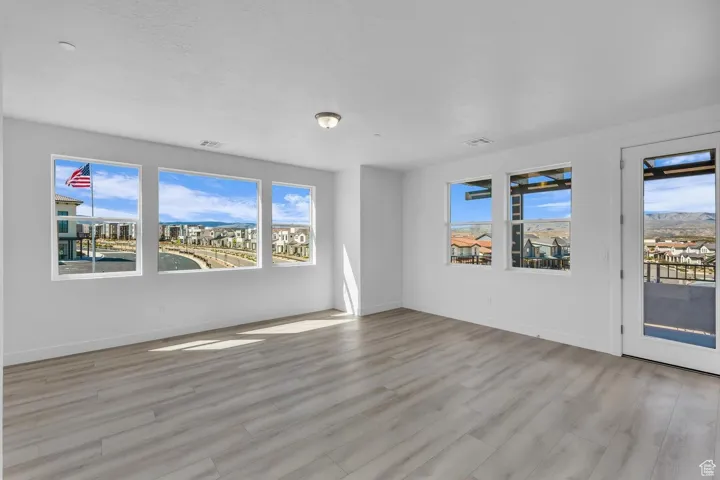 Unfurnished room featuring wood finished floors and a textured ceiling