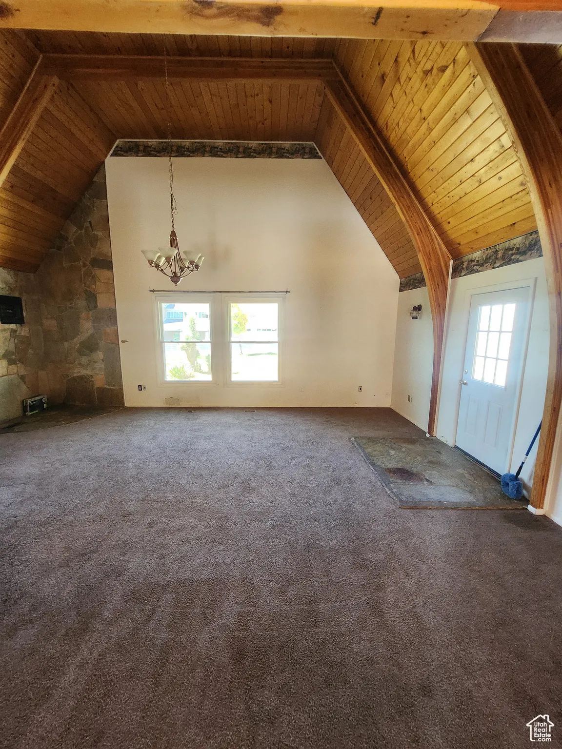 Bonus room featuring a wooden ceiling with exposed beams, carpet floors, and high vaulted ceiling