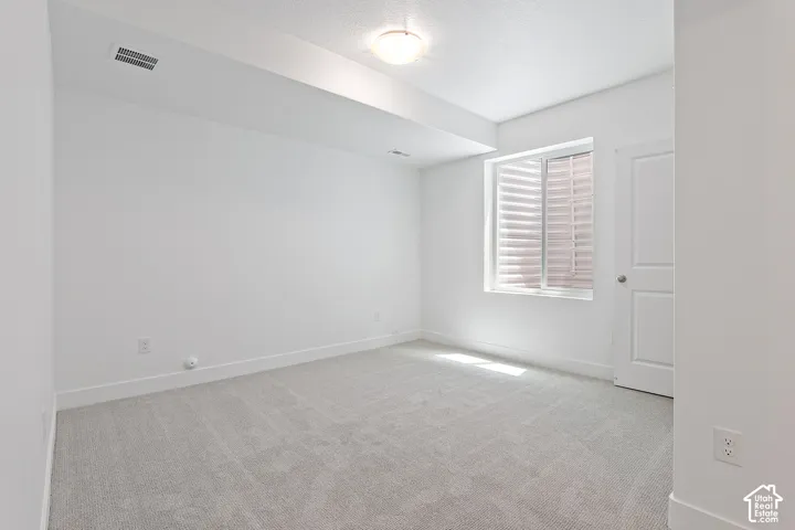 Carpeted room with baseboards and a textured ceiling
