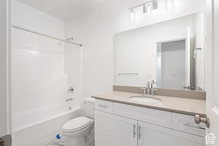 Bathroom with vanity, shower / tub combination, and marble finish floors