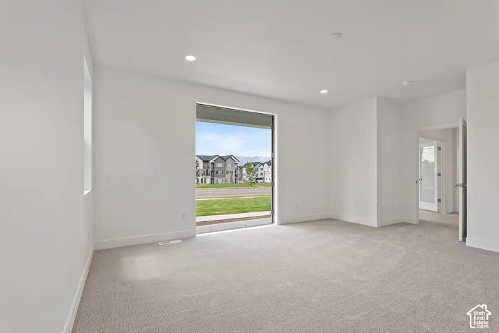Unfurnished room featuring light colored carpet and recessed lighting