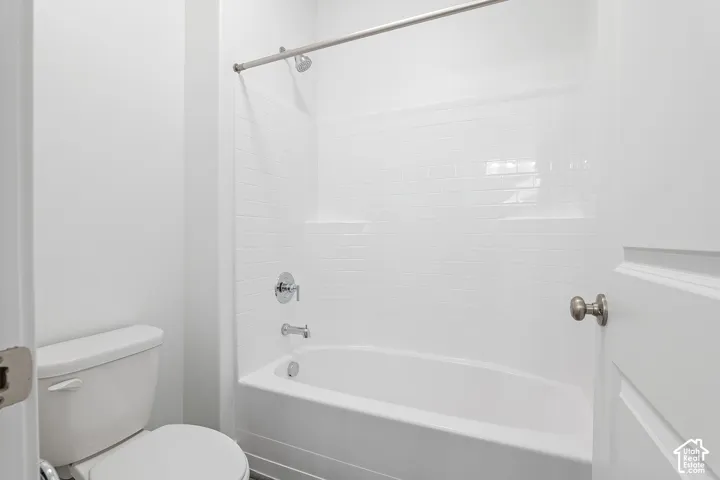Bathroom featuring toilet and shower / tub combination