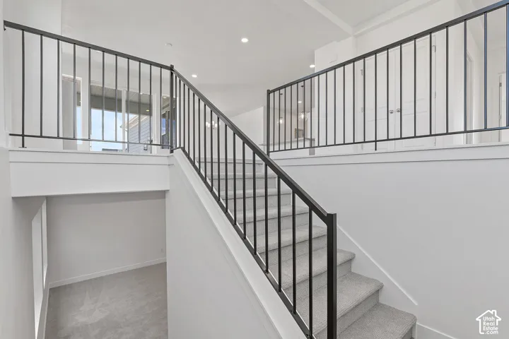 Staircase featuring carpet and recessed lighting