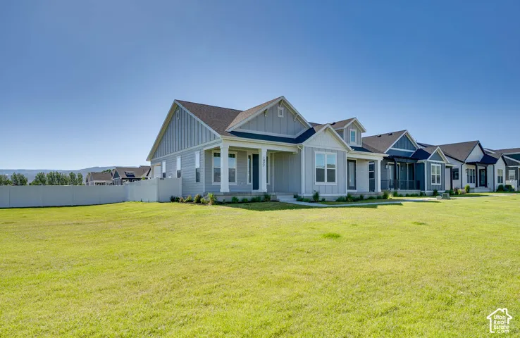 Light blue siding exterior with white trim and a covered front porch