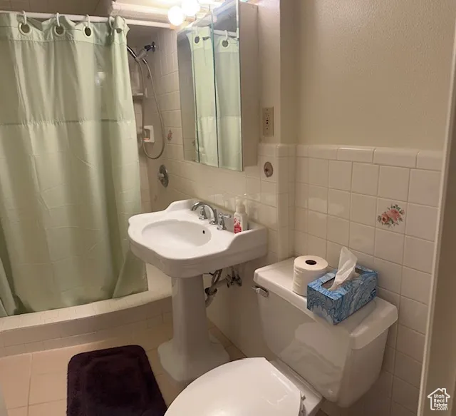 Bathroom with tile walls and wainscoting