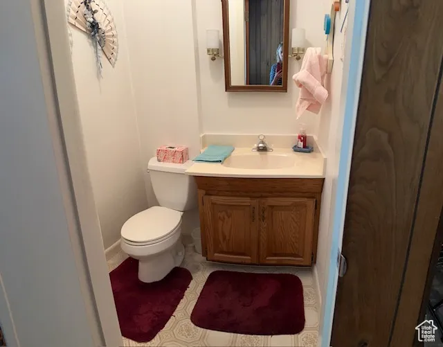 Half bath featuring vanity and toilet