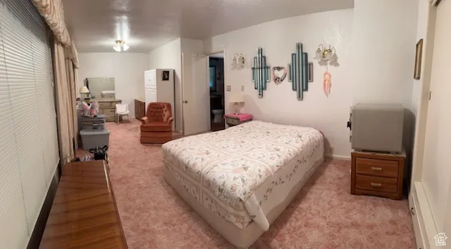 Bedroom featuring a baseboard heating unit