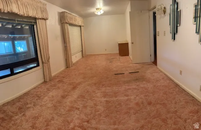 Hallway featuring carpet floors