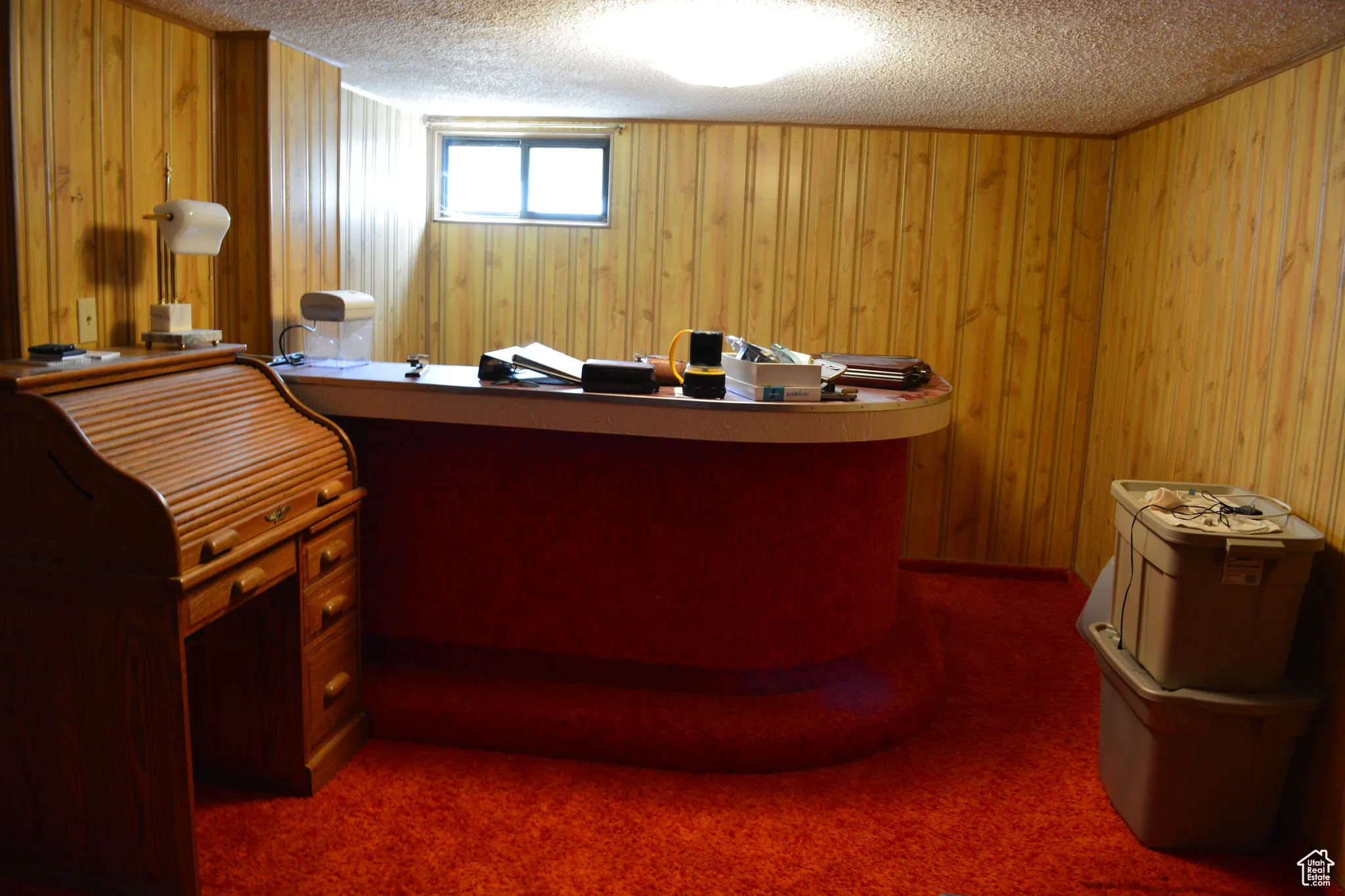 Welcome area with a textured ceiling and wooden walls