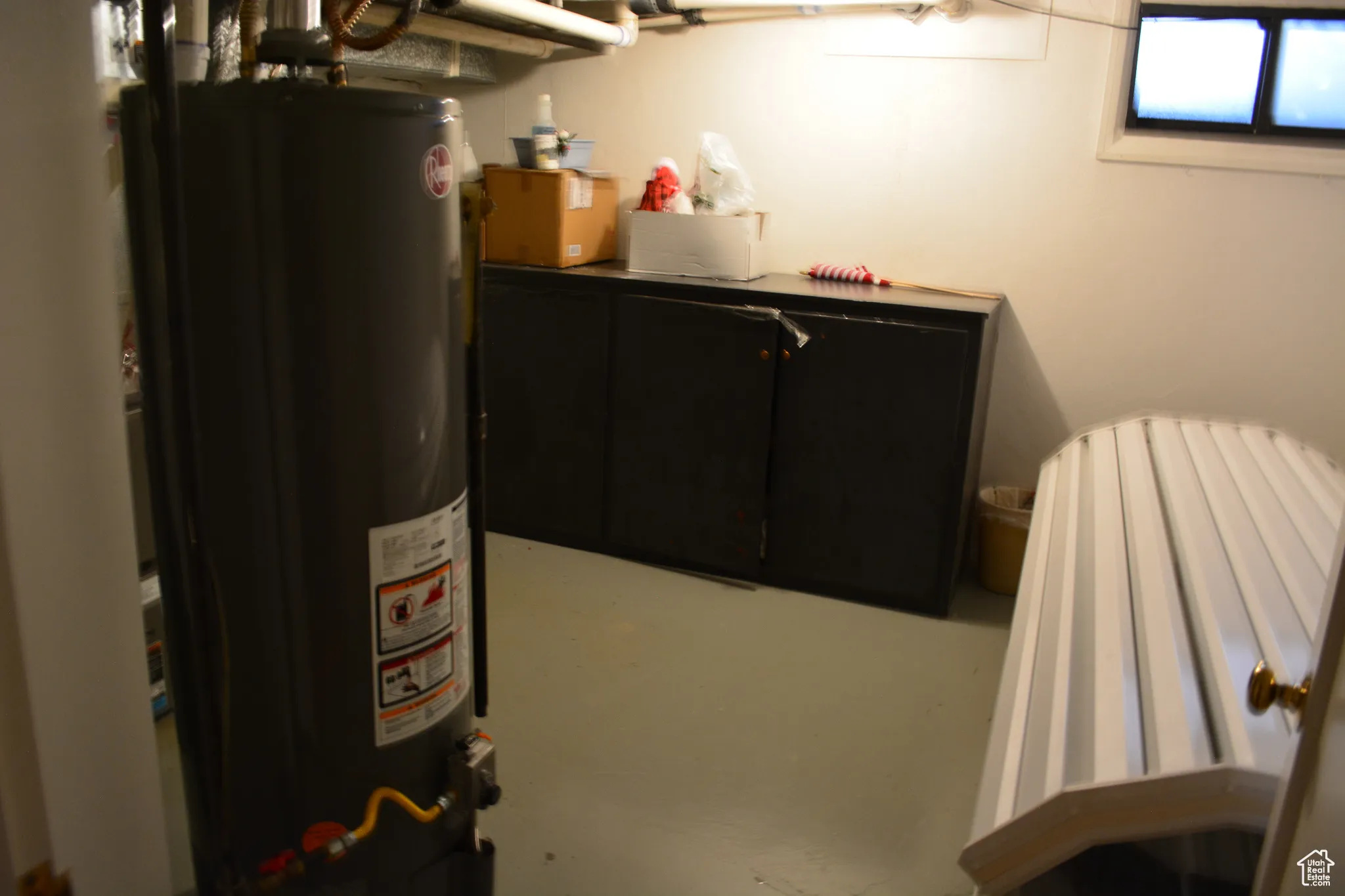 Basement with water heater and tanning bed