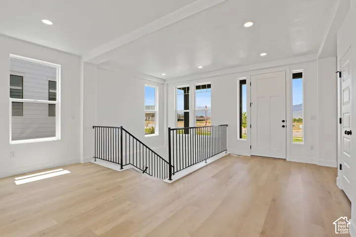 Foyer with light wood-style floors, plenty of natural light, and recessed lighting