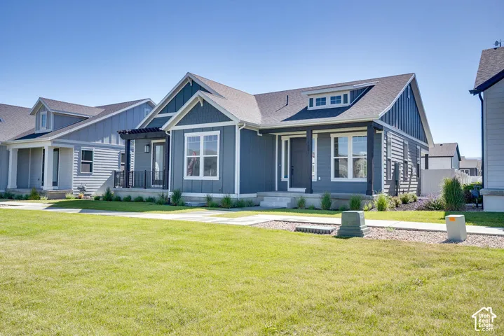 Modern ranch-style home featuring a dark gray exterior with white trim