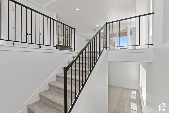 Stairs featuring carpet floors and recessed lighting