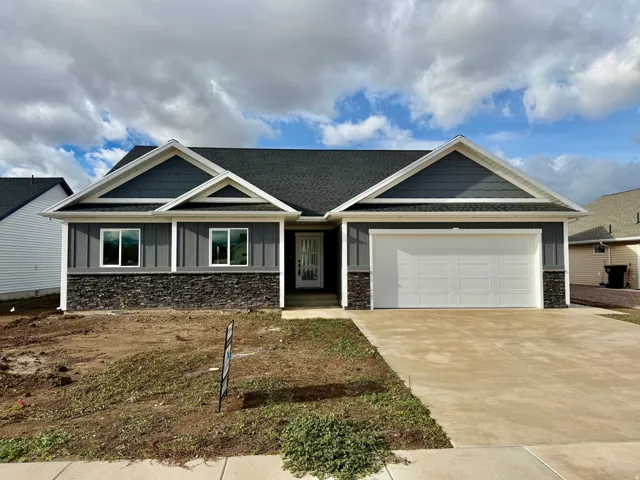 Craftsman house featuring stone siding, concrete driveway, a garage, and a shingled roof