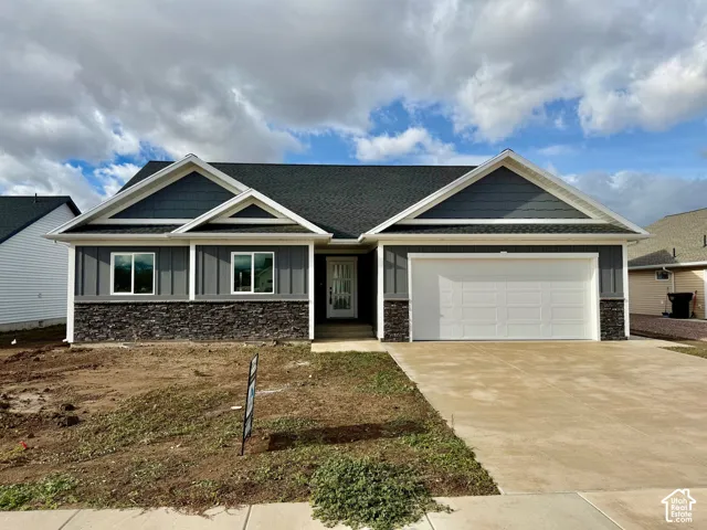 Craftsman house featuring stone siding, concrete driveway, a garage, and a shingled roof