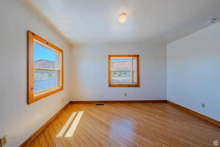 Empty room with light wood finished floors and baseboards
