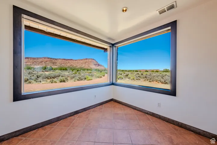 Spare room featuring a mountain view and tile patterned floors