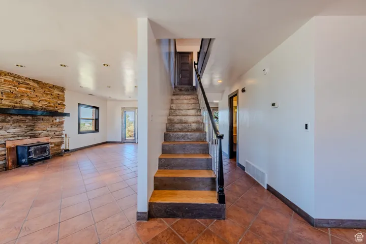 Stairs featuring tile patterned flooring and recessed lighting